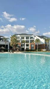 a large swimming pool in front of a building at The blyde 1 bedroom in Pretoria