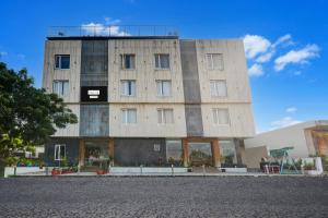 a large building with a lot of windows at Palette by CheckIn Goverdhan Villas Formerly The White Fresco in Udaipur