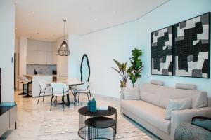 a living room with a couch and a table at Stunning 1 Bed in Trilogy, Limassol Seafront in Limassol +58 photos