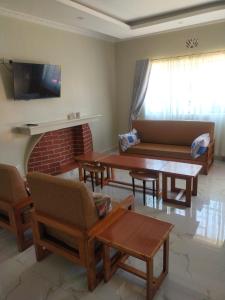 a living room with a couch and a fireplace at Green Garden in Juja