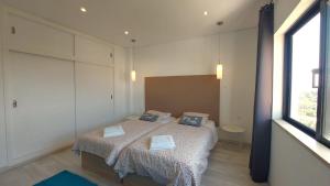 a bedroom with a bed with two pillows on it at AL Sunset in Albufeira +15 photos