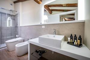 a bathroom with a sink and a toilet at Garibaldi Luxury apartments in Prato +112 photos