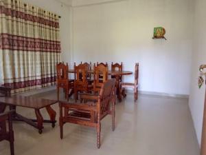 a dining room with wooden tables and chairs at Tha Ivory villa in Nattarampota