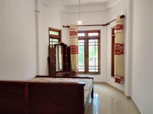 a living room with a table and a window at Tha Ivory villa in Nattarampota