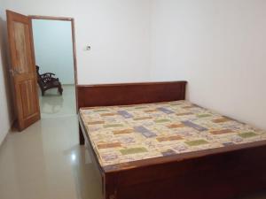 a bedroom with a bed with a quilt on it at Tha Ivory villa in Nattarampota