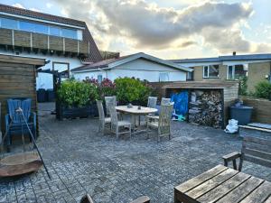 a patio with a table and chairs in a backyard at Cozy guest house with terrace in Aalborg +6 photos