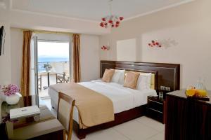a hotel room with a bed and a balcony at Ilia Mare in Ilia
