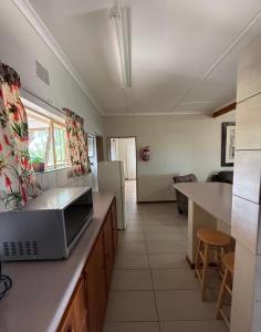 a kitchen with a counter top with a microwave at East Gate Rest Camp in Buitepos