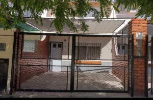 a gate in front of a building at Complejo el Cuy in Las Grutas