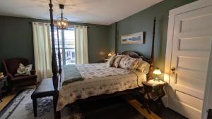 a bedroom with a bed and a window at Rose & Thistle B&B Lunenburg in Lunenburg