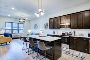 a kitchen with wooden cabinets and a large island with bar chairs at Fairway in Altoona