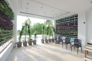 a patio with chairs and plants in a building at Srushti Resort in Daulatābād