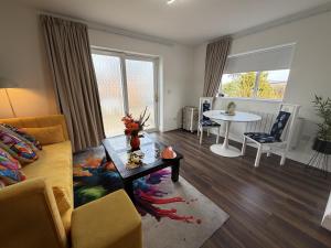 a living room with a couch and a table at Hillcrest House Holiday Suites in Donegal