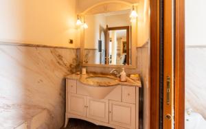 a bathroom with a sink and a mirror at Villa Infinity Garda in Peschiera del Garda
