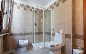 a bathroom with a toilet and a shower at Villa Infinity Garda in Peschiera del Garda