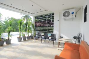 a patio with a table and chairs and a wall of wine bottles at Srushti Resort in Daulatābād