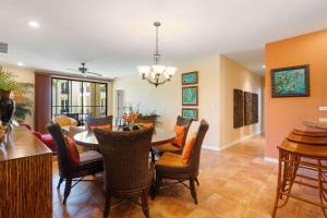 a dining room and living room with a table and chairs at Vibrant 3-Bedroom Condo with Resort Amenities, Pools & Beach Club Access in Coco +41 photos