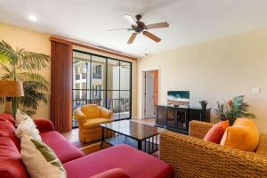 a living room with a couch and chairs and a table at Vibrant 3-Bedroom Condo with Resort Amenities, Pools & Beach Club Access in Coco