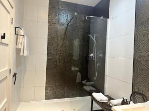 a bathroom with a shower with a glass door at Double Ensuite Ground Floor Easy to Cardiff in Cardiff