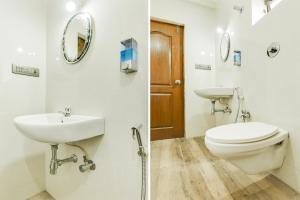 a bathroom with a toilet and a sink at Super Hotel O Dabolim Near Goa International Airport in Goa +64 photos