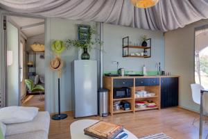 a living room with a refrigerator and a table at Amavi Luxury Tent Corfu in Víngla
