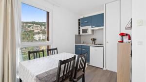 a kitchen and dining room with a table and a window at Virginia N 410 2P4 in Grasse +4 photos