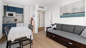 a living room with a couch and a table and a kitchen at Virginia N 410 2P4 in Grasse
