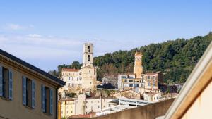a view of a city with a clock tower and buildings at Virginia N 410 2P4 in Grasse