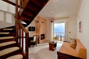 a living room with a staircase and a fireplace at Ilia Mare in Ilia