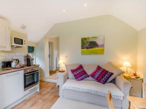 a living room with a couch and a kitchen at 1 Bed in York oc-g0032 in Crayke