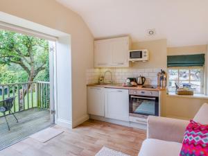 a kitchen with white cabinets and a balcony at 1 Bed in York oc-g0032 in Crayke +6 photos