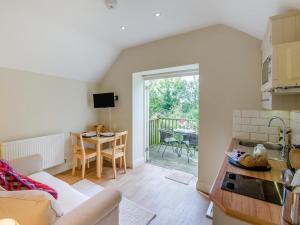a kitchen and living room with a couch and a table at 1 Bed in York oc-g0032 in Crayke