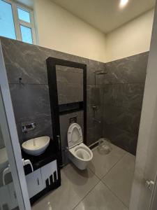 a bathroom with a toilet and a sink at Horizon house in Vagamon