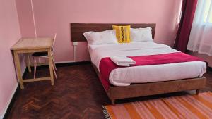 a bedroom with a large bed and a table at Triple SSS Hotel in Nairobi +38 photos