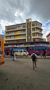 a group of people walking in front of a building at Triple SSS Hotel in Nairobi