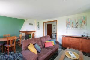 a living room with a couch and a table at Charming house with great views in Brison-Saint-Innocent