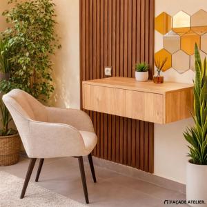 a chair in a room with potted plants at Le Calme a Temara in Temara