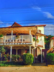 a house with a balcony with flowers on it at Хотел "Лодката" in Tutrakan