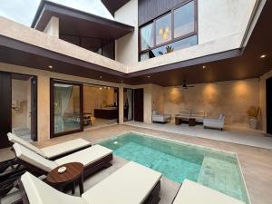a house with a swimming pool and a patio at Eden Villas Lombok in Kuta Lombok