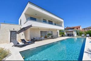 a house with a swimming pool in front of a house at Villa Mila in Vabriga
