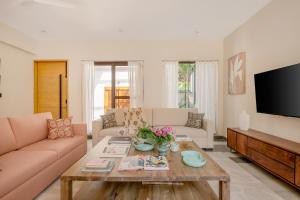 a living room with a couch and a table at Lindsay Manor AkSh Private Pool 4BHK Lift in Arpora