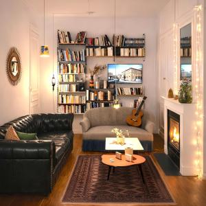 a living room with a couch and a fireplace at LA MAISON FIVES - Esprit Hôtel Design - Lille in Lille