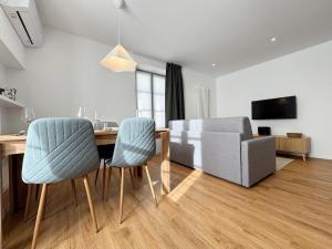 a living room with a table and chairs and a couch at Carducci Holiday Home in Chiavenna