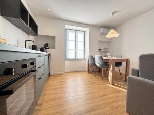 a kitchen and dining room with a table and a dining room at Carducci Holiday Home in Chiavenna