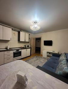 a kitchen with a large bed in a room at Apartment in Almaty