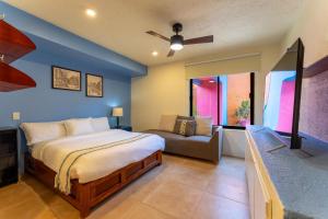 a bedroom with a bed and a couch at 4000 - Casa San Felipe in Oaxaca City