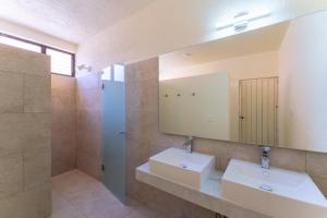 a bathroom with two sinks and a mirror at 4000 - Casa San Felipe in Oaxaca City +25 photos