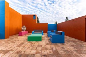 a patio with colorful chairs and a table at 4000 - Casa San Felipe in Oaxaca City