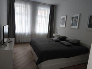 a bedroom with a bed and a large window at HOME City Stay Chemnitz in Chemnitz