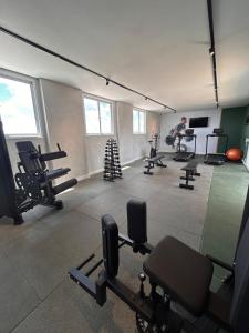 a man in a gym with several tread machines at City Core 2 Bedrooms by AP Smart in Campinas